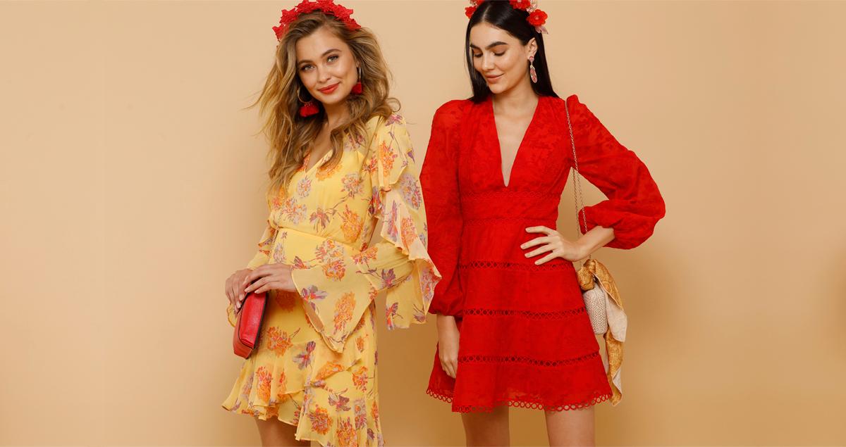 A woman wearing yellow floral dress with ruffled sleeves paired with red accessories for spring carnival race day.