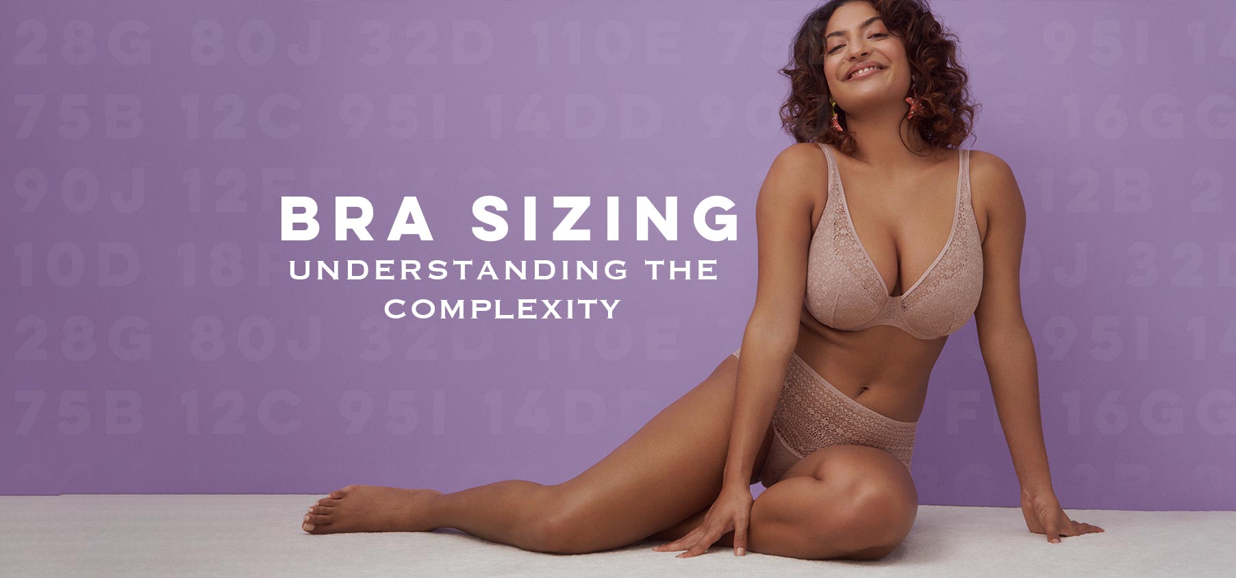 Woman sitting on floor in lingerie with Bra Sizing in the background