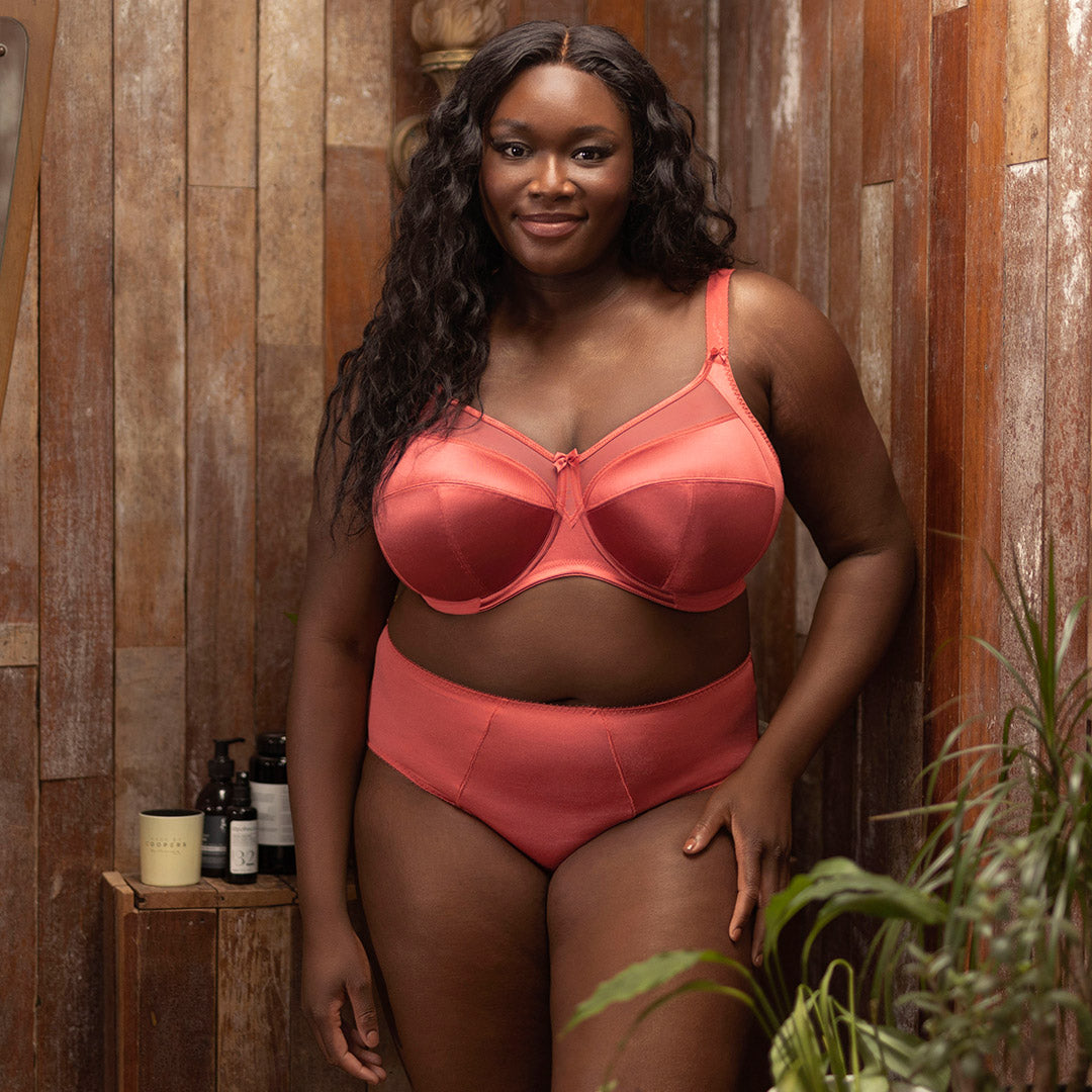 Coral satin bra and high-waisted briefs set from the goddess collection featuring smooth fabric and elegant design