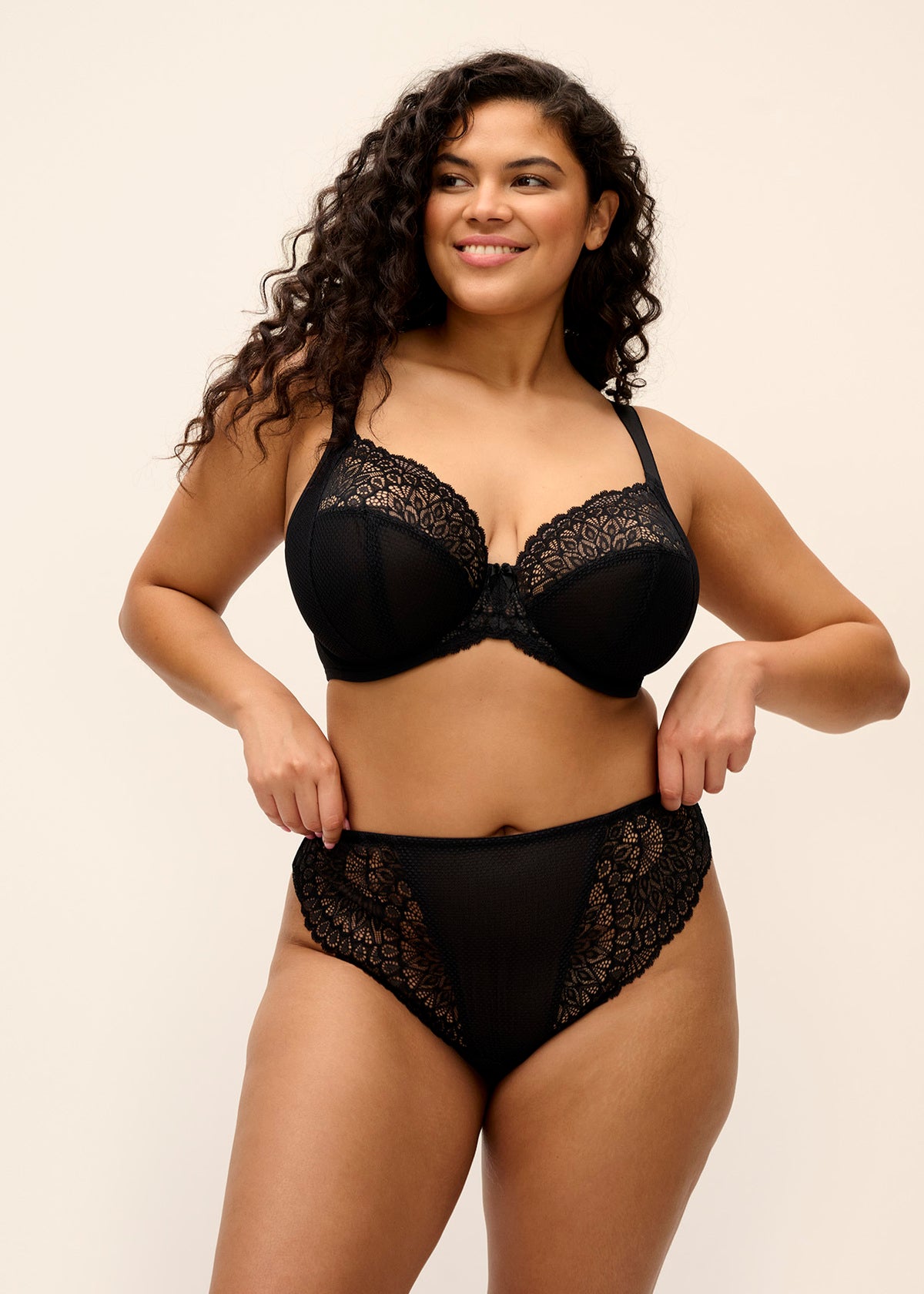 Black lace tiernie plunge bra and matching high-waisted panties set showcasing delicate lace fabric and elegant design