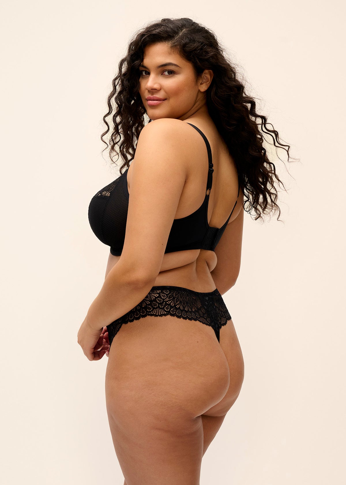 Black lace thong with delicate floral embroidery on waistband shown from the back matching tiernie plunge bra