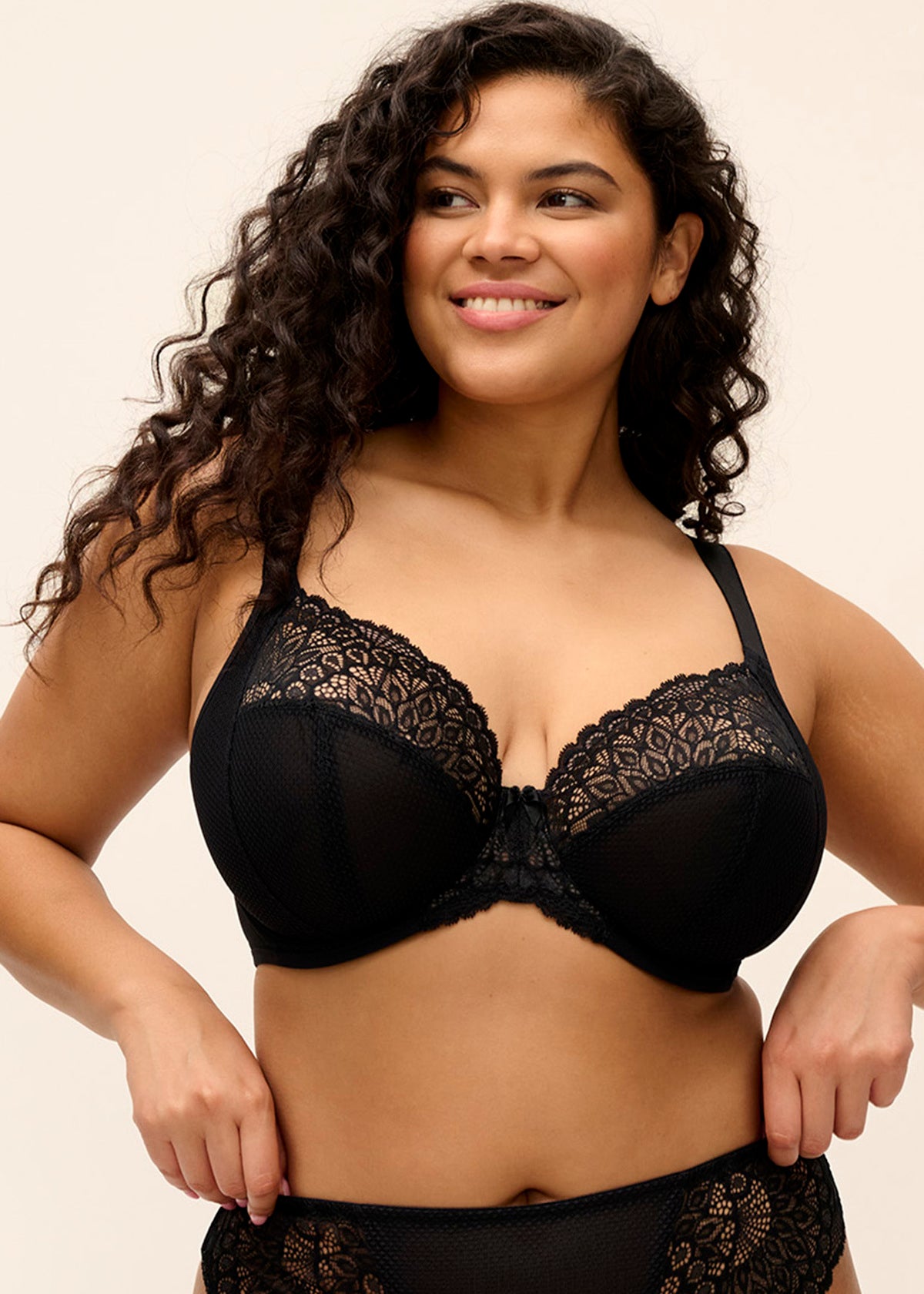 Black lace tiernie plunge bra with intricate floral patterns and smooth supportive cup design