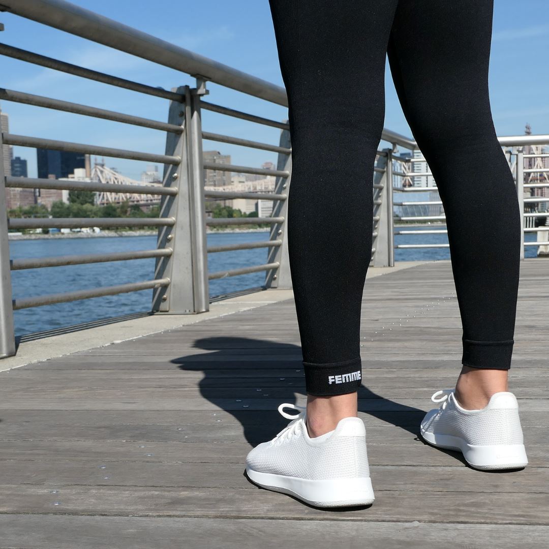 Black FEMME Pocket Leggings with femme branding on ankle cuffs and white sneakers