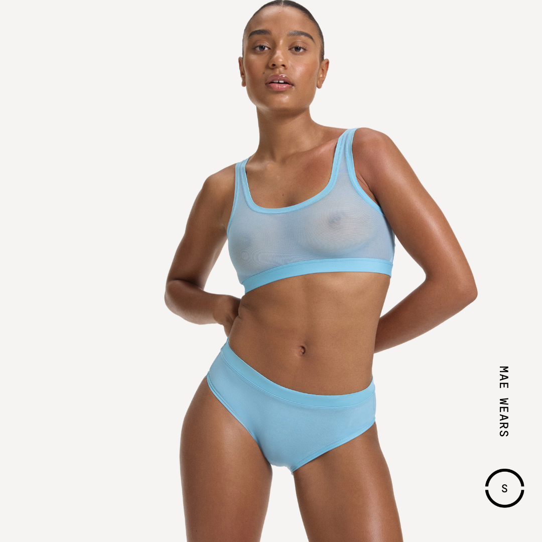 Light blue sheer mesh sports bra with solid band and matching high-waisted briefs