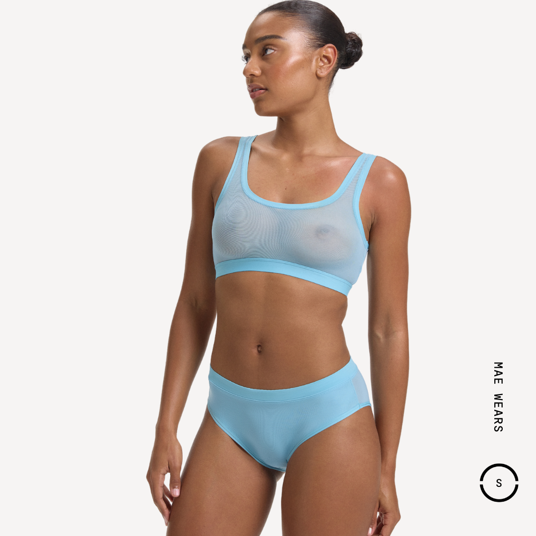 Light blue sheer mesh sports bra with trim and matching high-waisted briefs