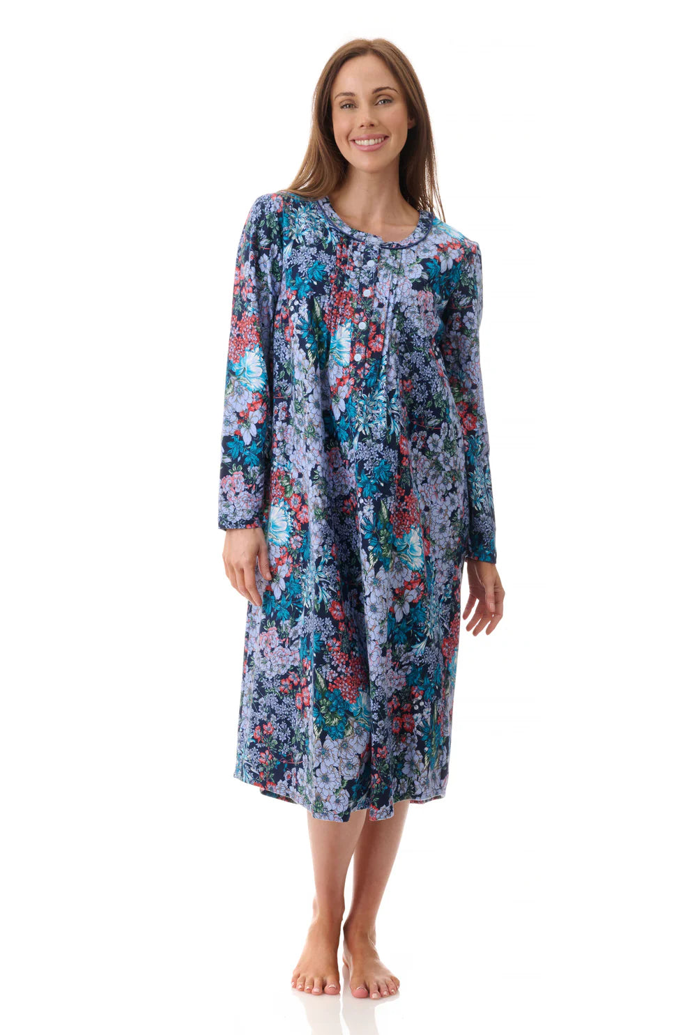 A woman wearing a soft blue and purple floral long-sleeved knee-length nightgown called Frida mid nightie
