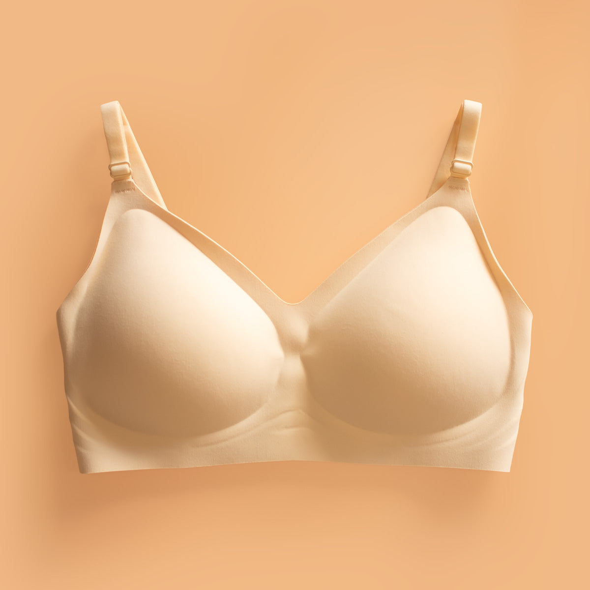 Beige Ava seamless shaping bra with underwire, adjustable straps, and smooth molded design for comfortable support