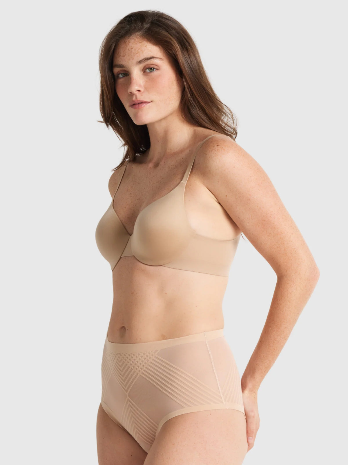 Beige seamless bra and sheer power waisted brief with subtle geometric paneling for comfortable support
