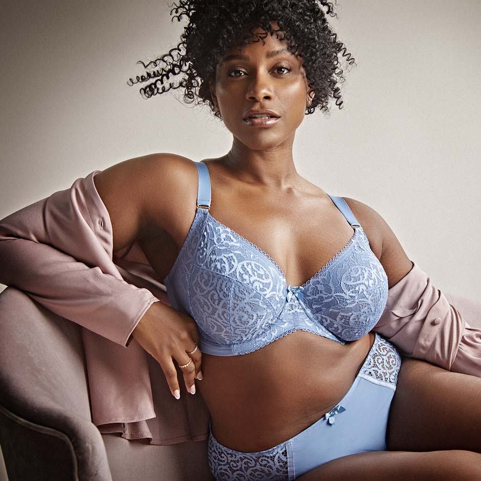 Seated woman in a light blue lingerie set
