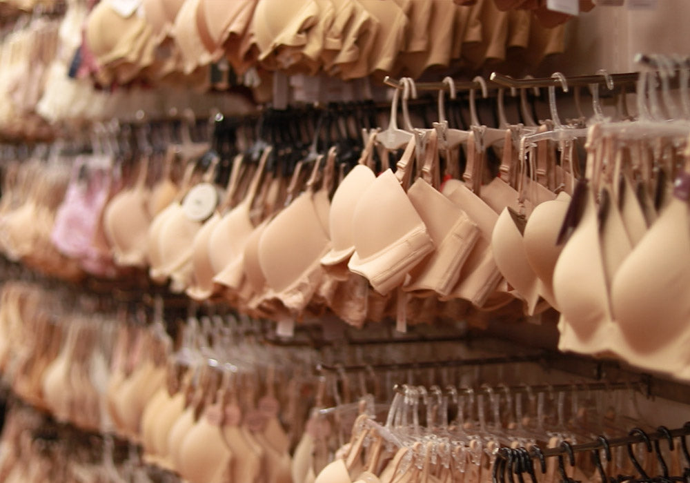 Wall of beige bras in a lingerie store
