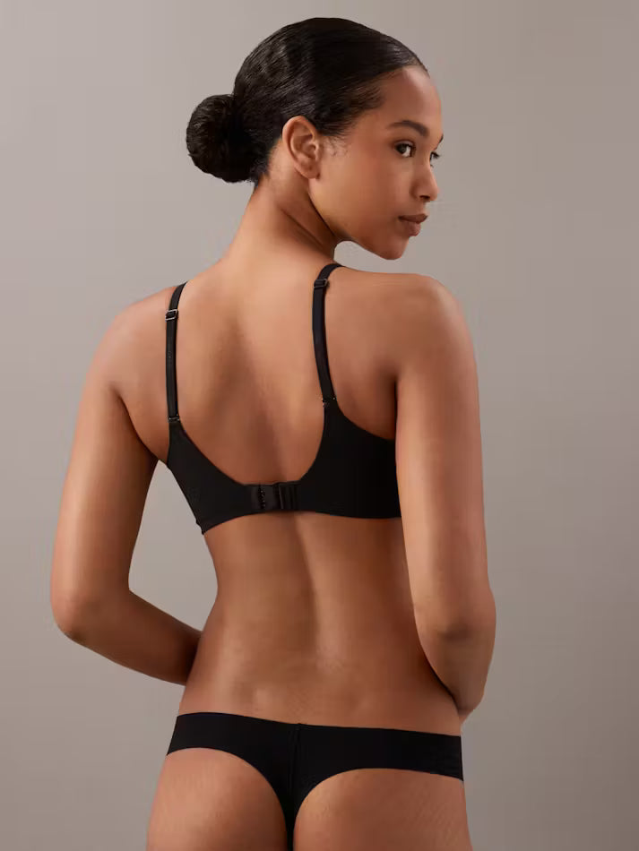 Black seamless perfectly fit lightly lined full coverage bra with thin straps and back closure shown from the back