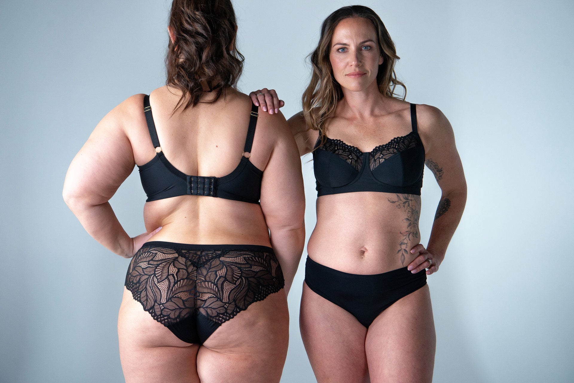 Black lace wirefree bra with adjustable straps and central clasp paired with matching floral lace underwear