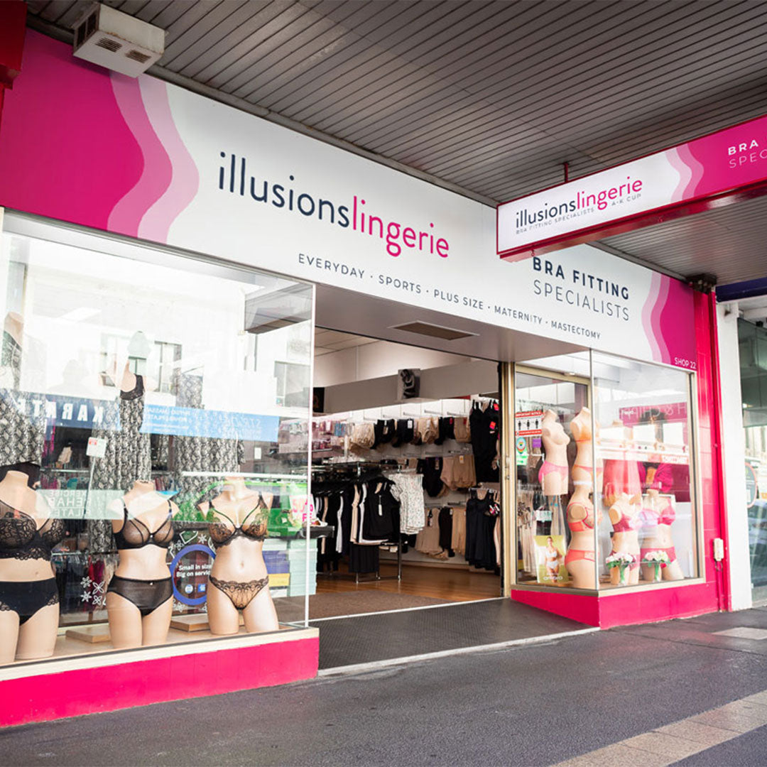 Illusions Lingerie store front with mannequins and lingerie displayed.