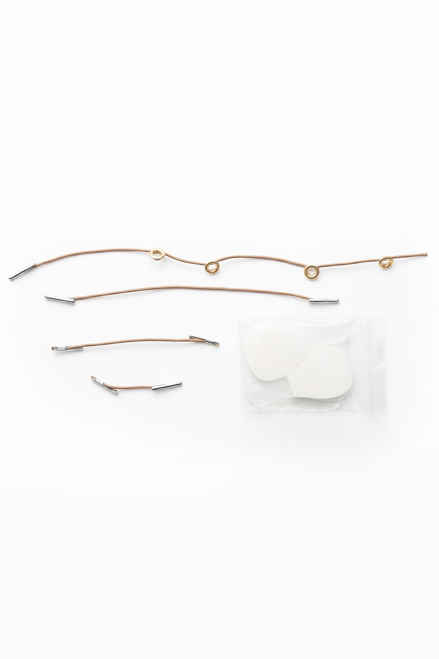 Set of gold-toned metal face lift tape chain links with silver-tone ends and a clear bag of white circular components