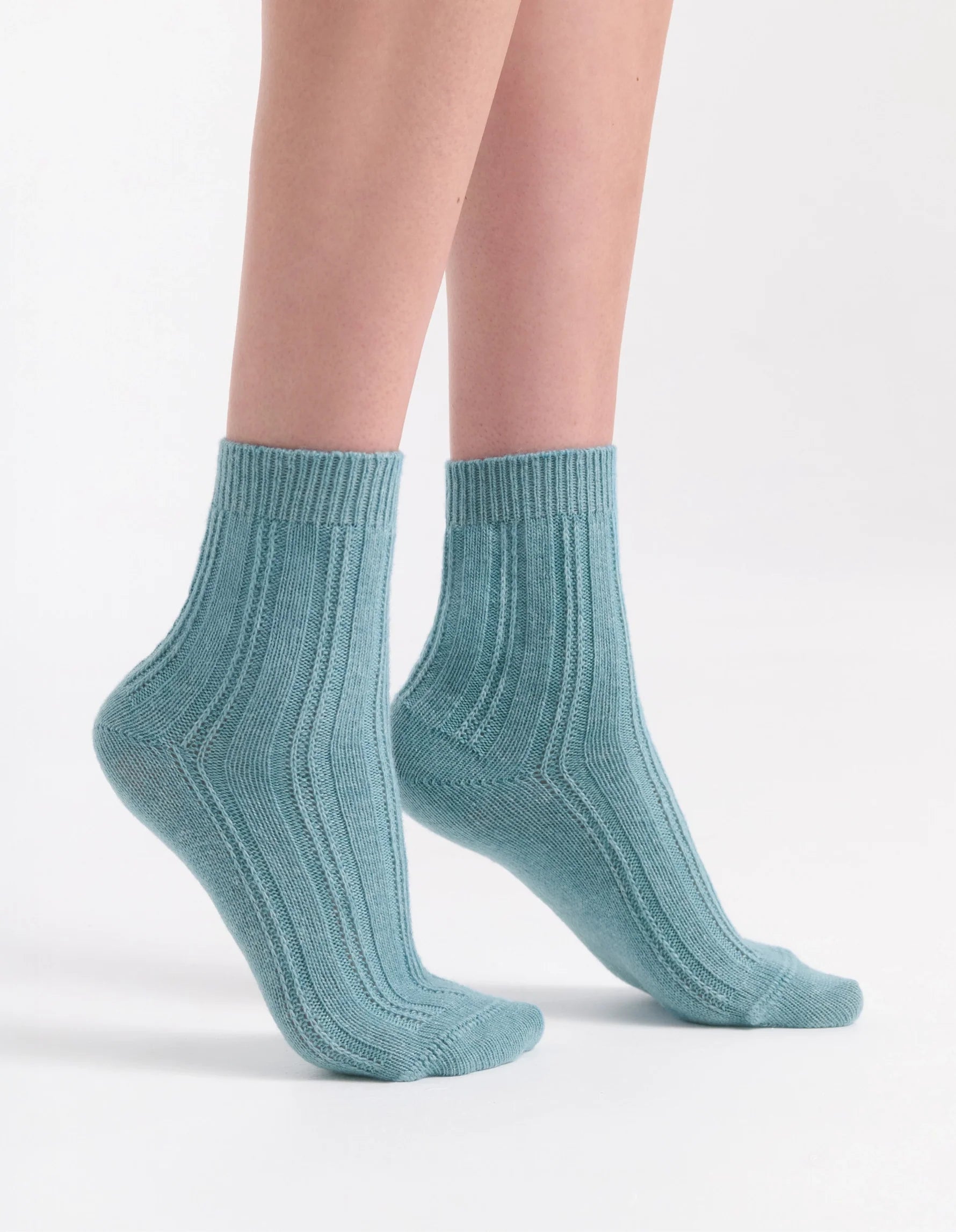 A pair of light teal ribbed knit ankle socks with a soft textured pattern from angelina cable crew sock collection
