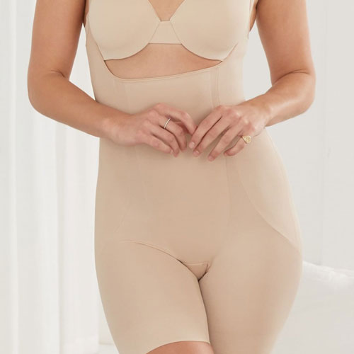 Woman wearing Miraclesuit beige underbust body suit and leg