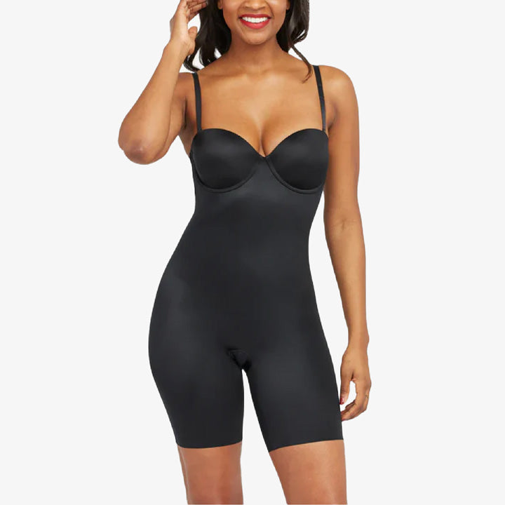 Woman wearing a black shapewear bodysuit on a white background