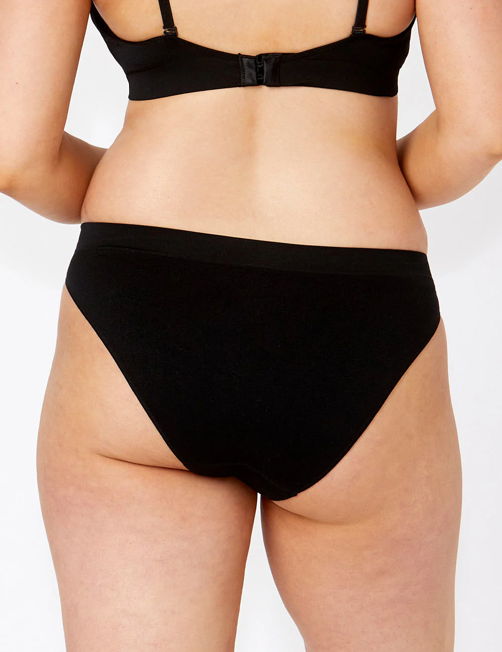 Bare Essentials Bikini: black seamless briefs with stretchy fabric and thin straps