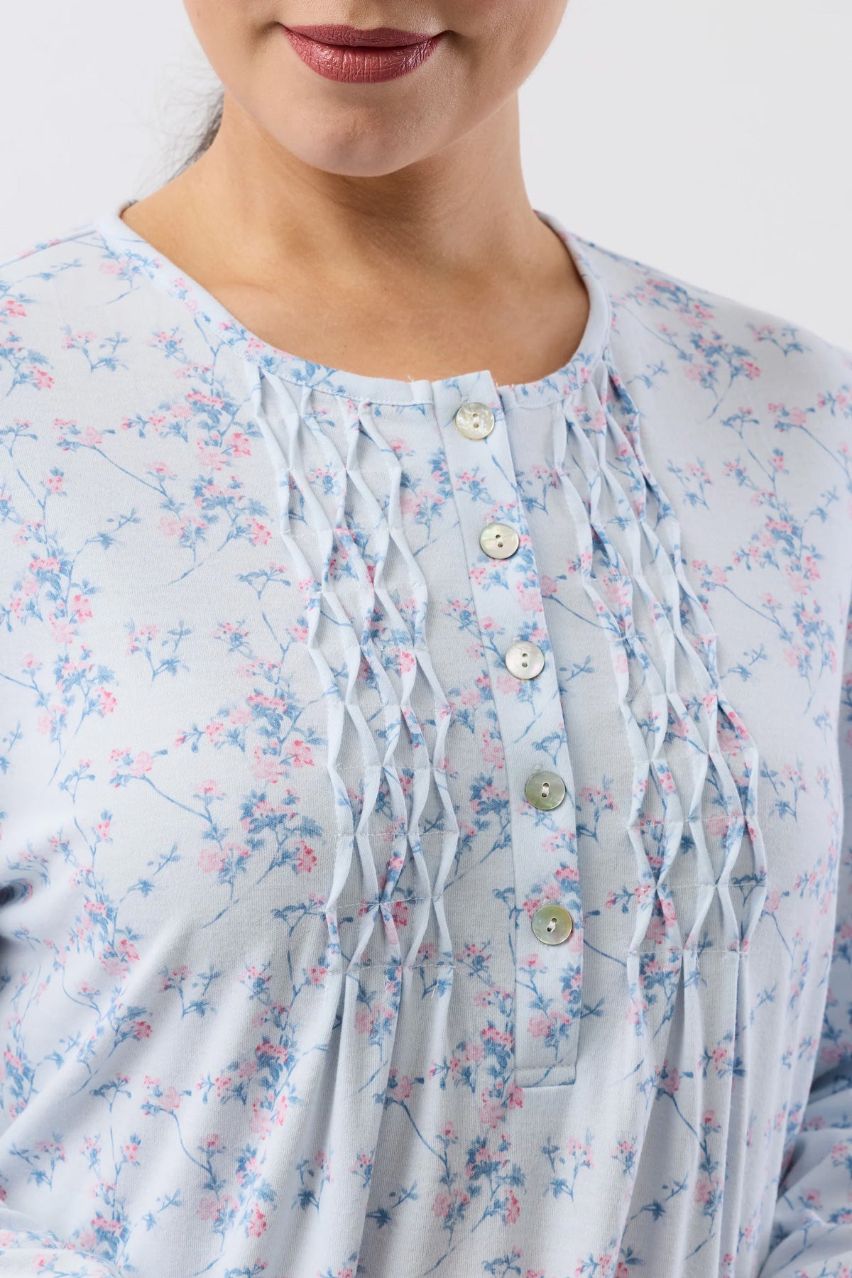 A light blue cherry blossom nightie blouse with delicate pink and blue floral pattern and gathered front with matching buttons
