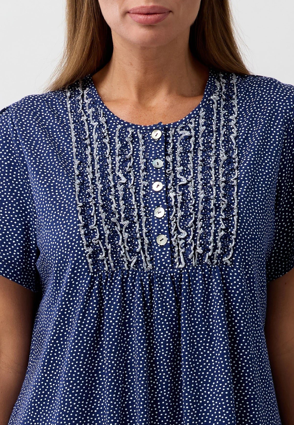 A navy blue confetti short sleeve nightie with white polka dots and silver embroidery along the neckline