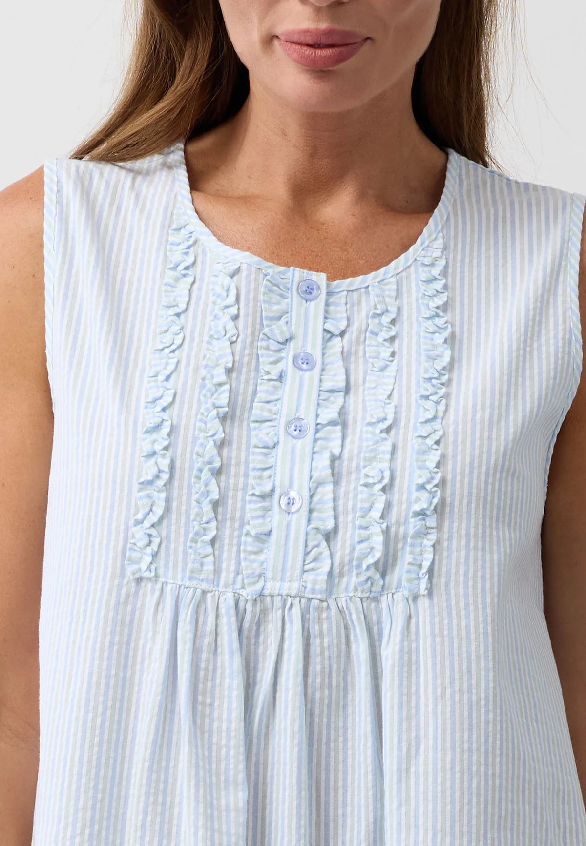 Stripe sleeveless nightie made of light blue and white striped fabric with ruffled trim and front buttons for comfortable sleepwear