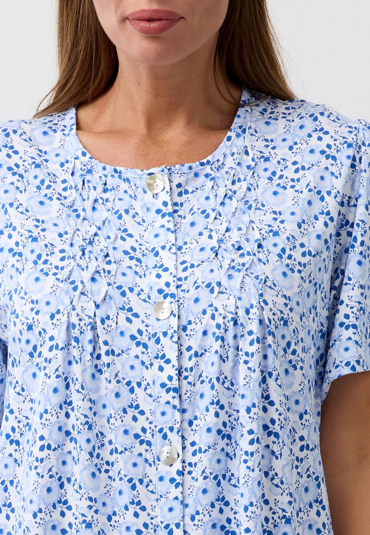 Light blue camellia brunch coat blouse with delicate floral pattern and button-front design in soft fabric