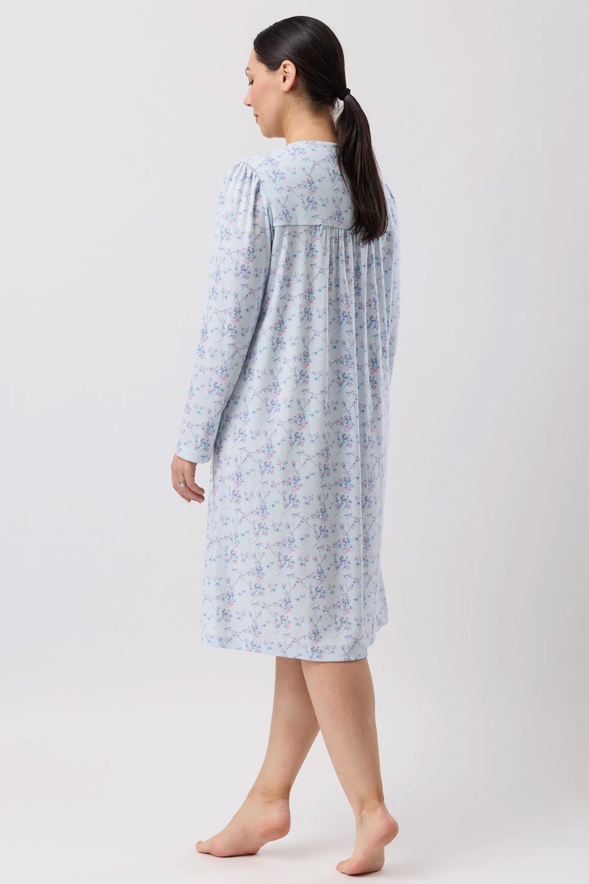 A soft light blue cherry blossom nightie with long sleeves and a delicate floral pattern and gathered neckline
