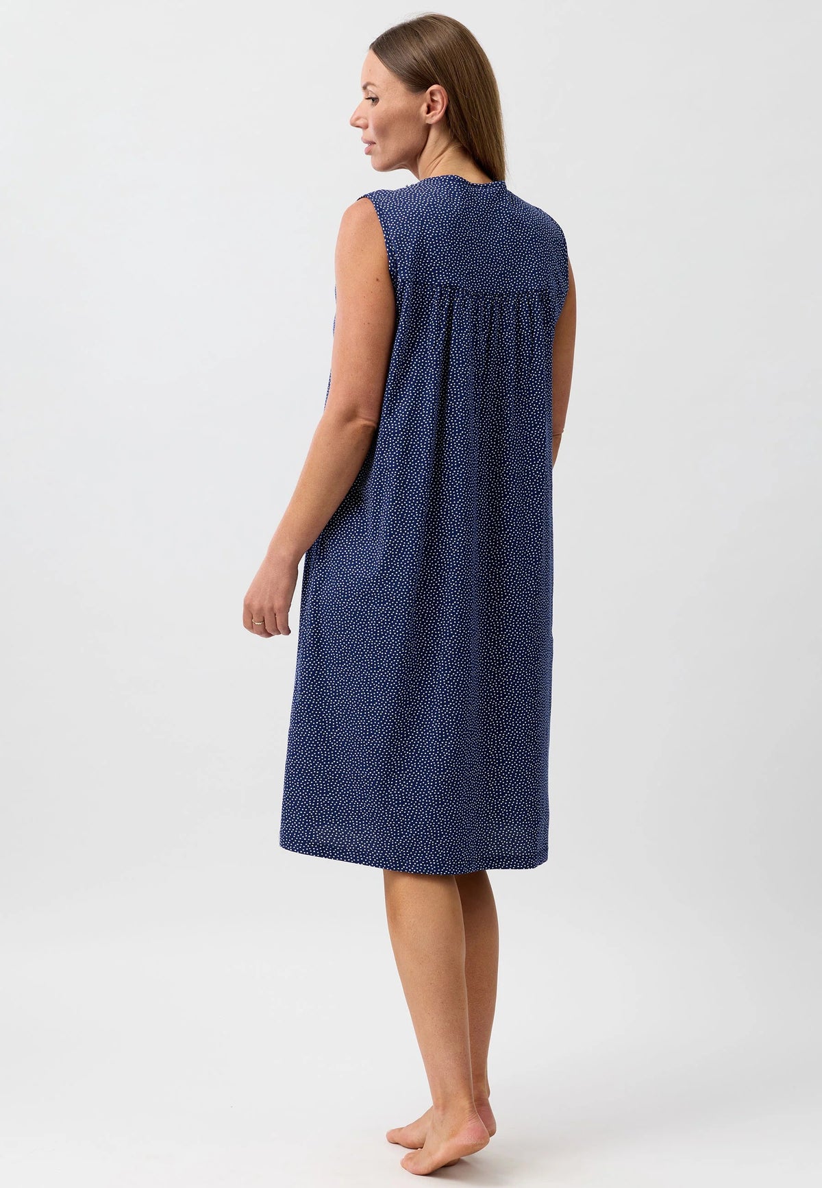 A navy blue confetti sleeveless nightie with a subtle white dot pattern and a gathered neckline