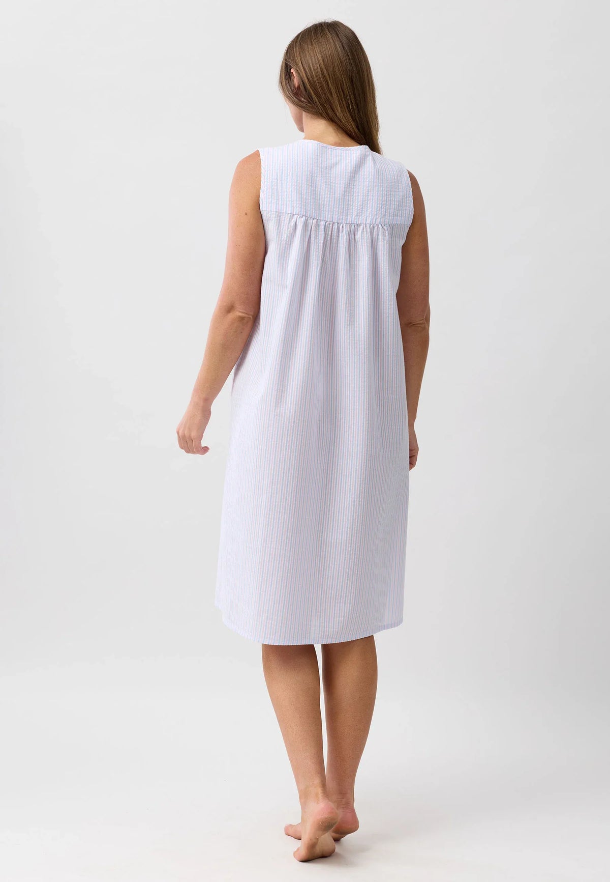 A sleeveless white and light blue striped cotton nightgown with a gathered neckline for comfortable sleepwear