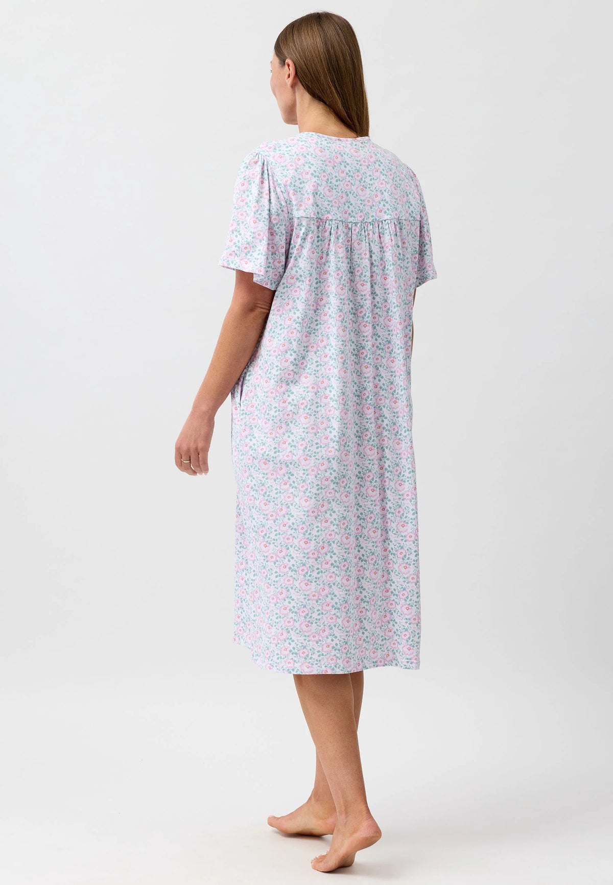A soft lavender camellia brunch coat with delicate pink and green floral pattern short sleeves and gathered neckline