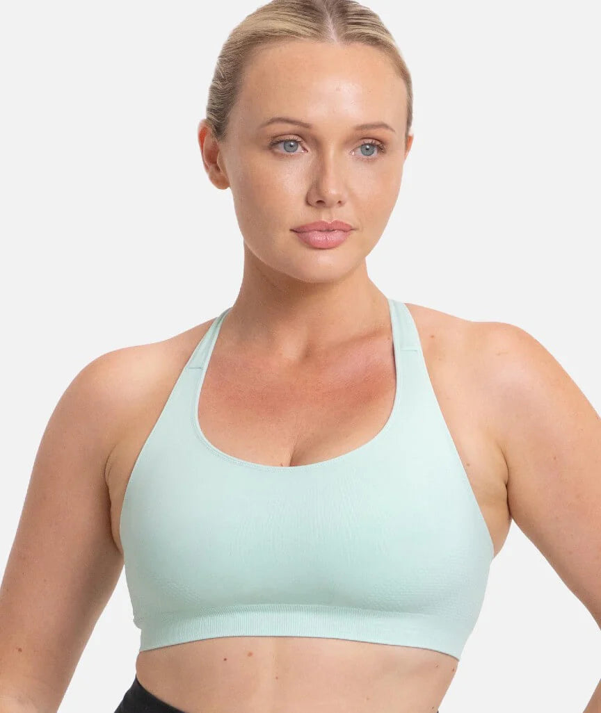 Light mint green Triaction Ultra Seamfree Top sports bra with racerback straps and ribbed hem