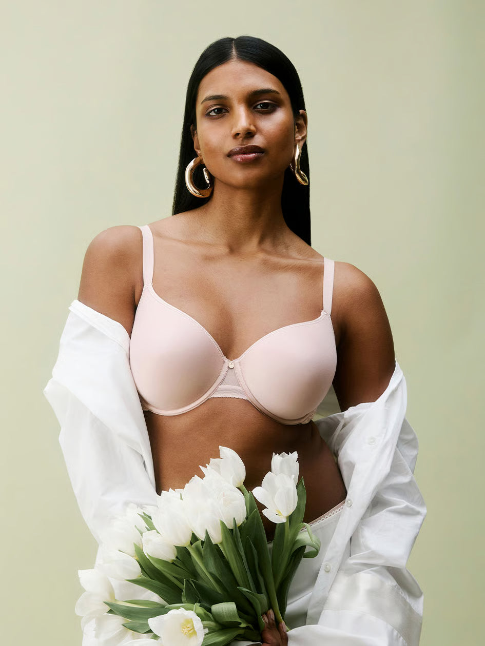 A blush-colored c jolie comfort convertible t-shirt bra with underwire thin straps and a smooth seamless design