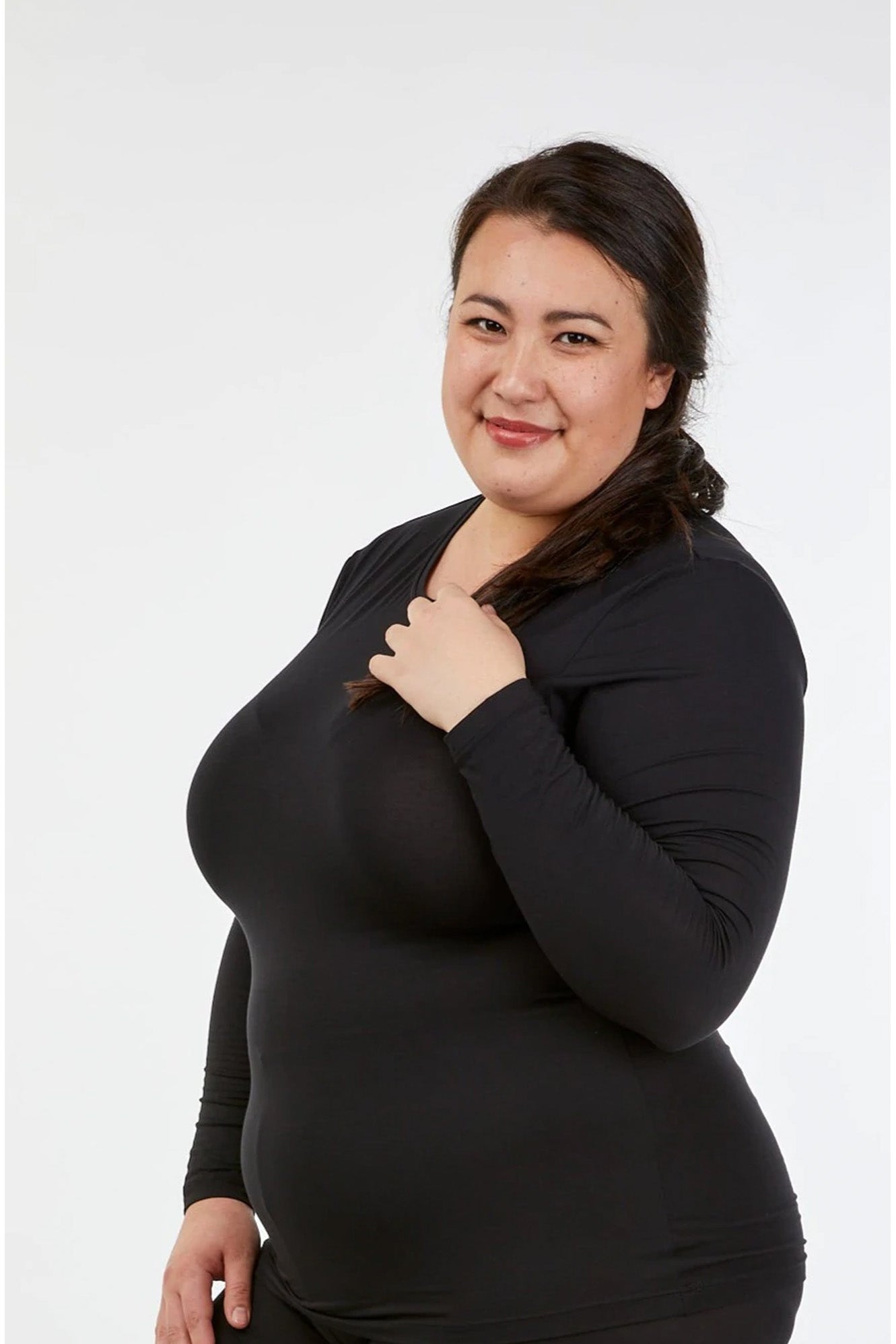 Full figure woman wearing Tani 79276 High Neck Long Sleeve in black side view