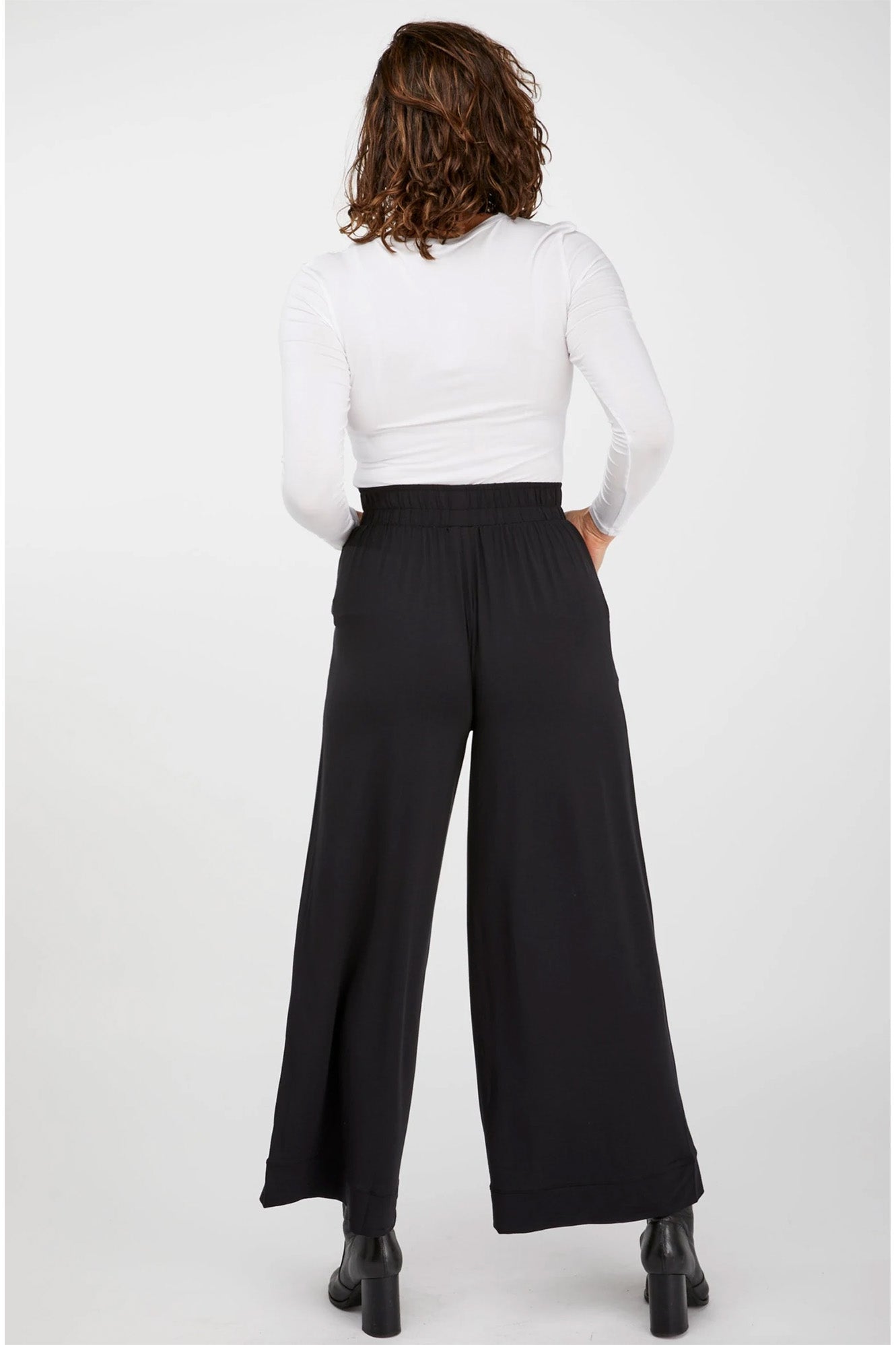 Young woman wearing Tani 79276 High Neck Long Sleeve in white back view