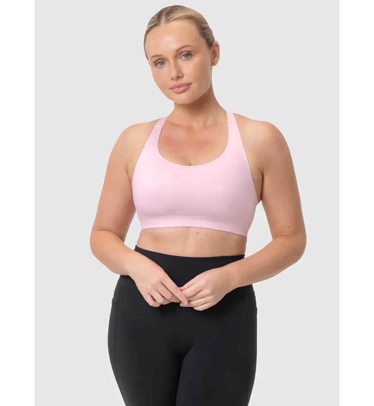 A soft pink triaction ultra seamfree top sports bra with thin straps and supportive seamless design