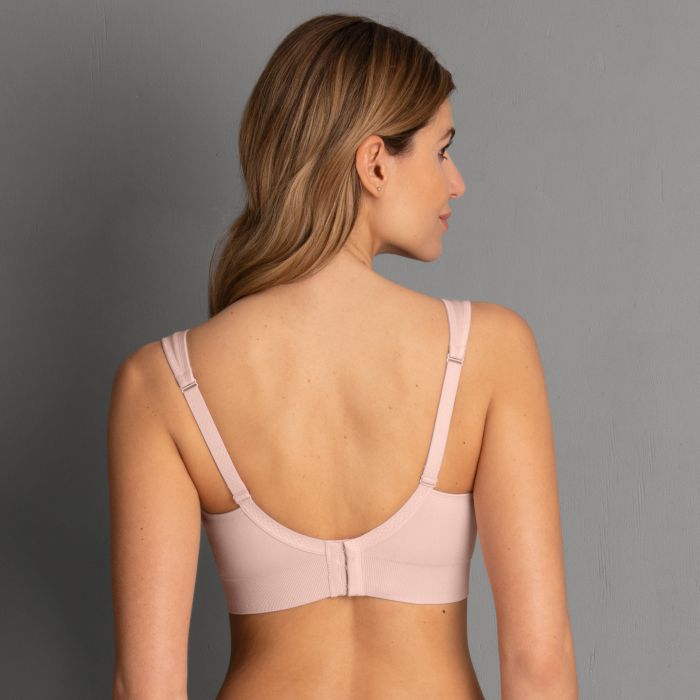 Back view of a soft pink lotta post mastectomy bra with thin straps and central back closure seamless design