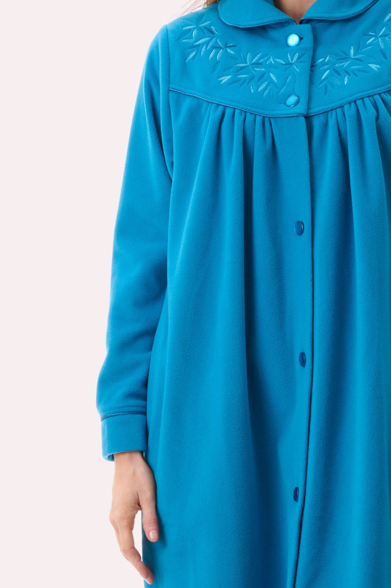 Short button gown in vibrant turquoise with long sleeves soft plush texture and delicate embroidered leaf collar