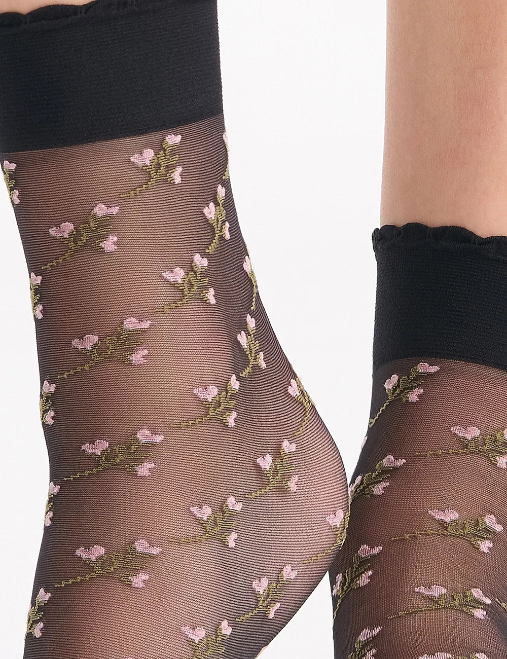 Black sheer bouquet anklet socks with delicate pink and green floral embroidery along the leg