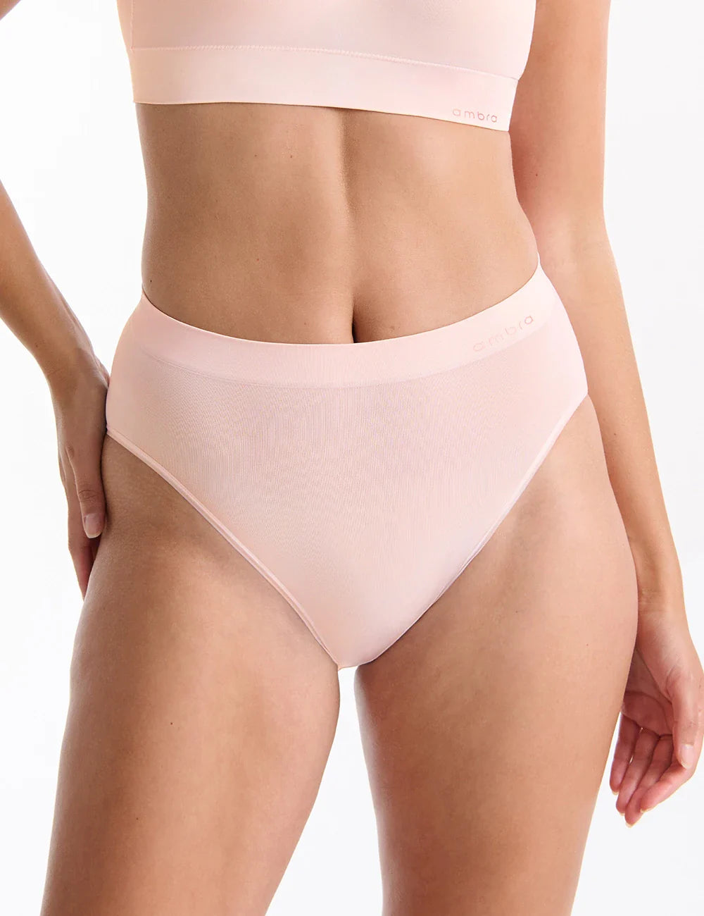 A soft blush pink bondi bare hi cut bikini bottom made of smooth stretchy ribbed fabric with branded waistband