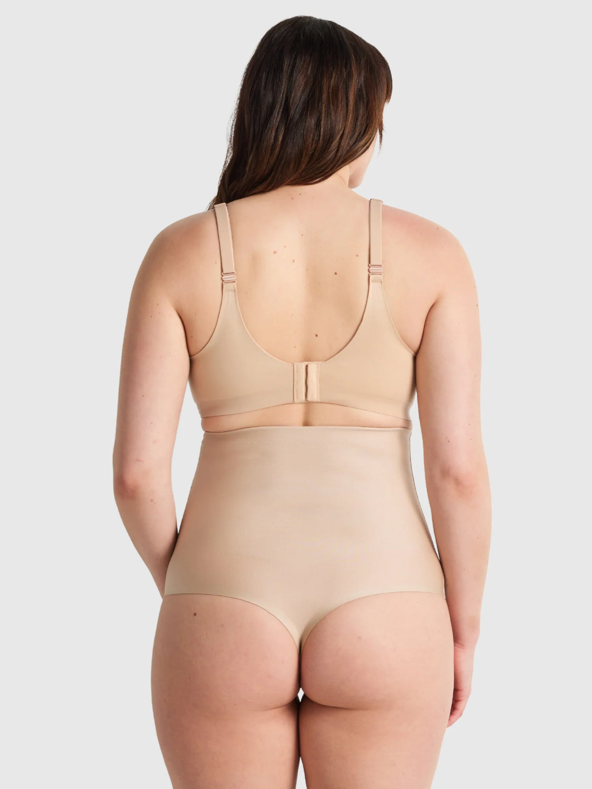Beige seamless high waisted thong shapewear set with thin straps designed for smooth body contouring
