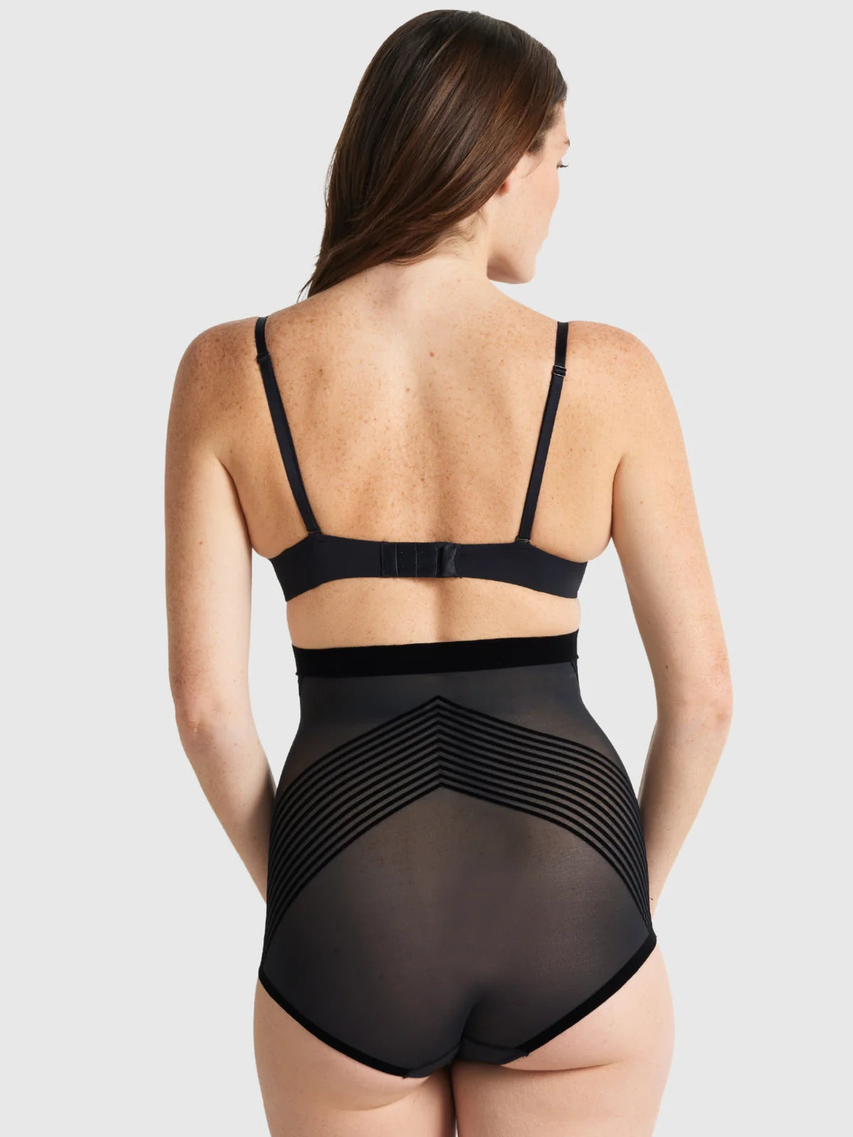 Black high waist brief shapewear with sheer mesh and striped paneling designed for shaping and support
