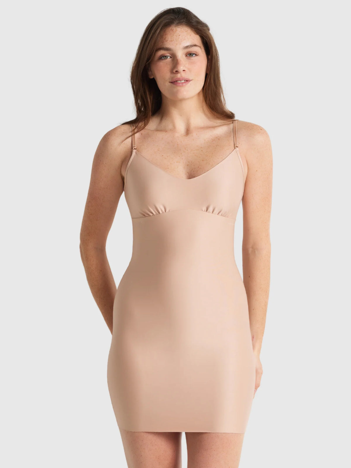 Beige seamless bodycon dress with thin spaghetti straps and flattering v neckline from the slip edit slip collection