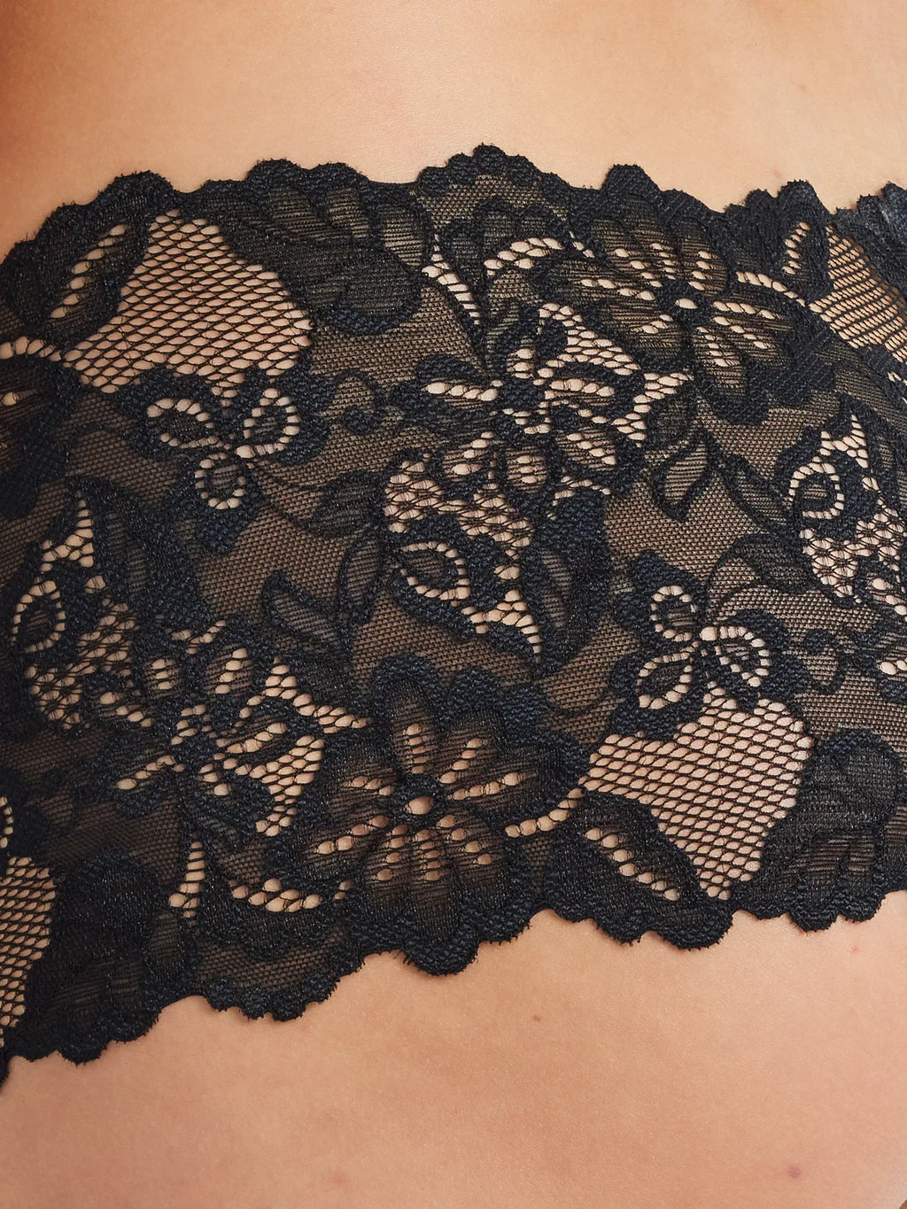 Black floral lace bra strap with delicate scalloped edges and intricate pattern shown on lace brazilian short back side