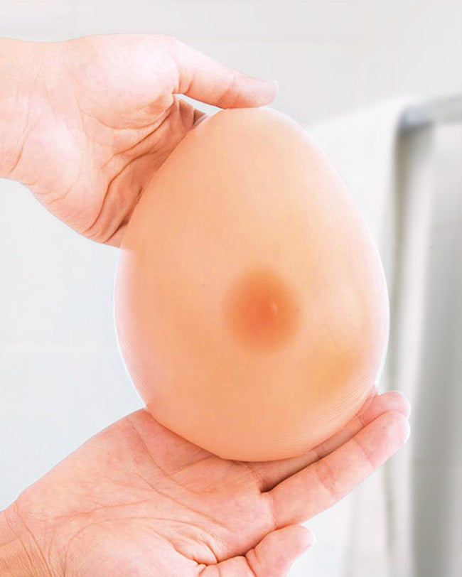 Hands holding silicone breast form