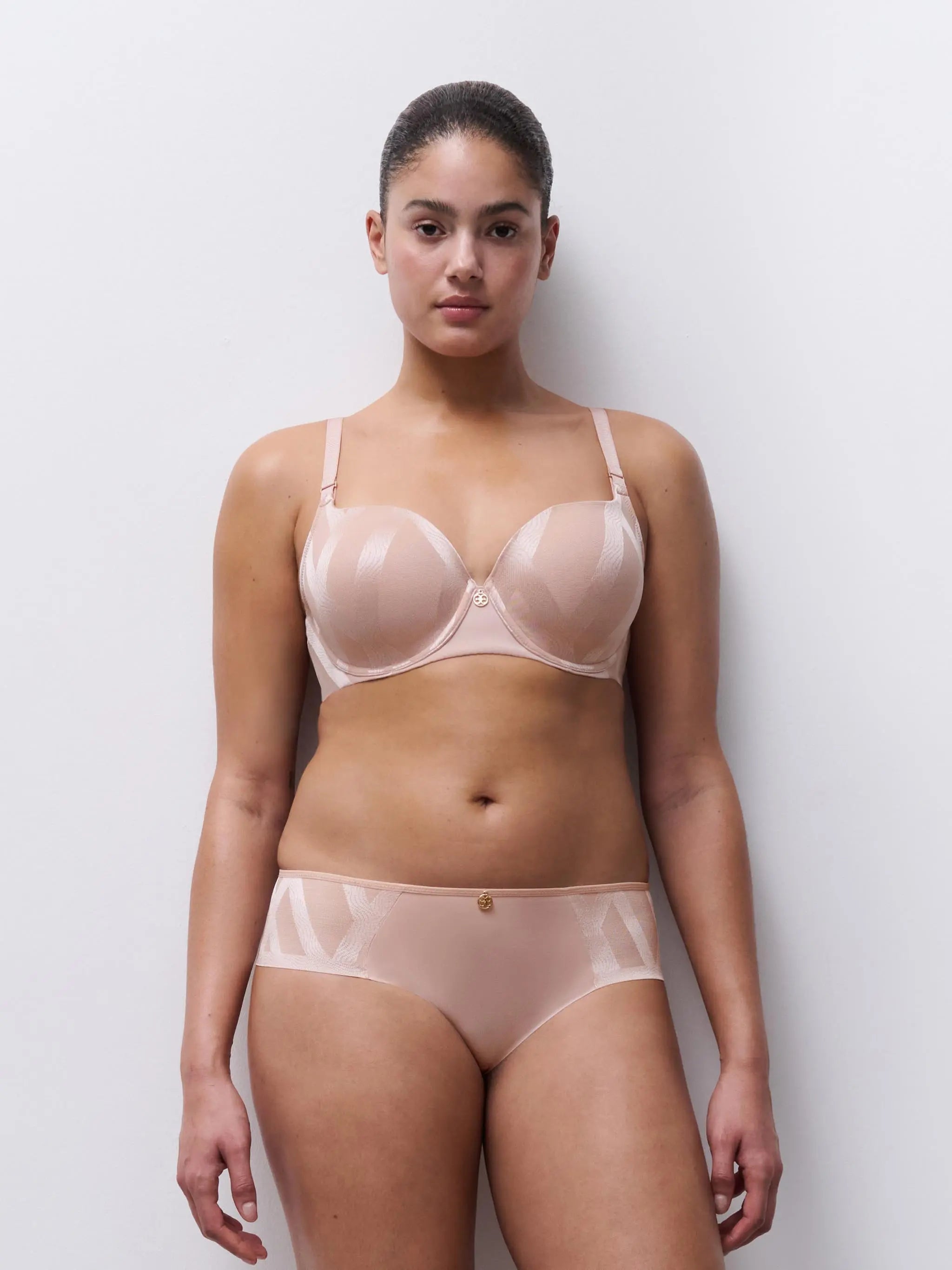 Nude-colored sheer mesh bra and high-waisted briefs set with delicate gold-tone hardware from glaze very covering series