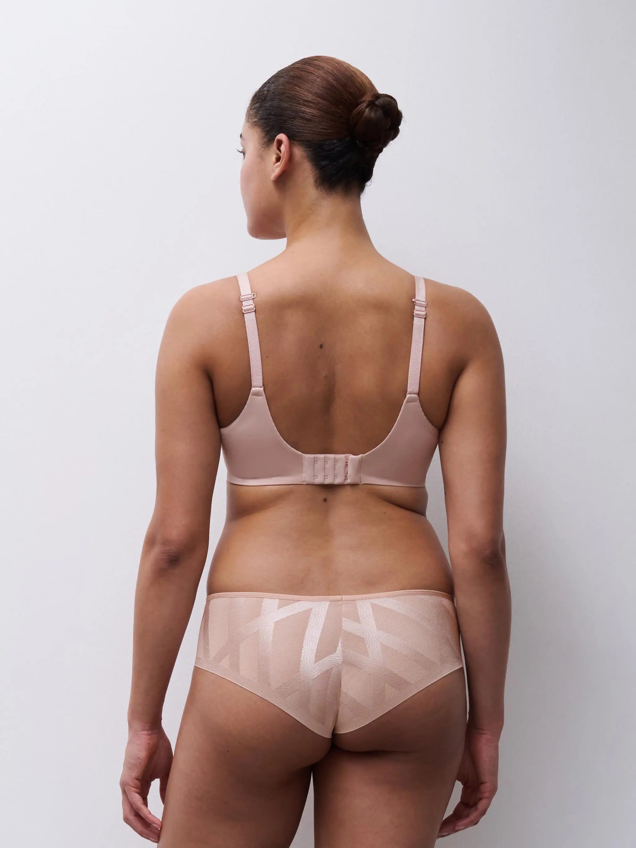 Beige glaze very covering seamless bra with adjustable straps and back clasp paired with high-waisted briefs with geometric pattern