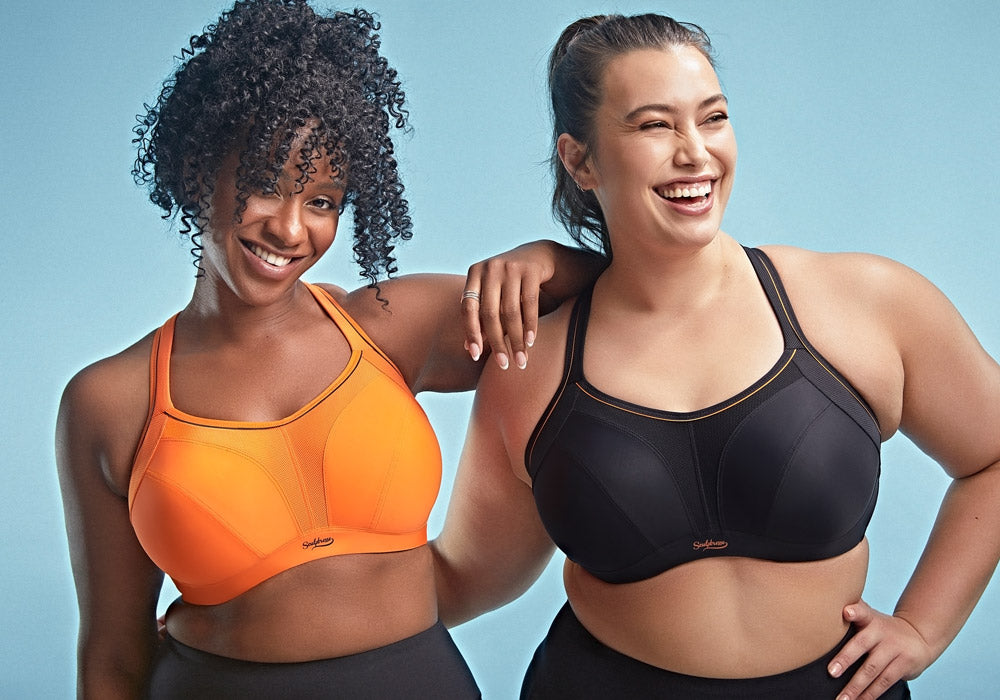Two full figure women in sports bras on a blue background