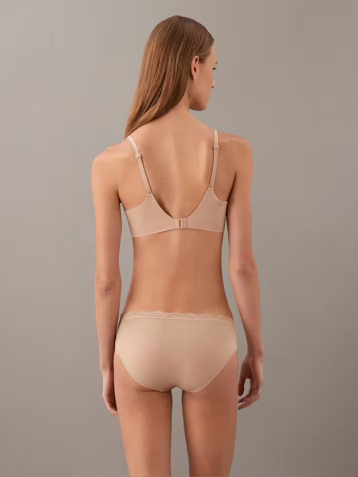 Beige seamless lightly lined full coverage bra with delicate lace trim and thin adjustable straps for comfort