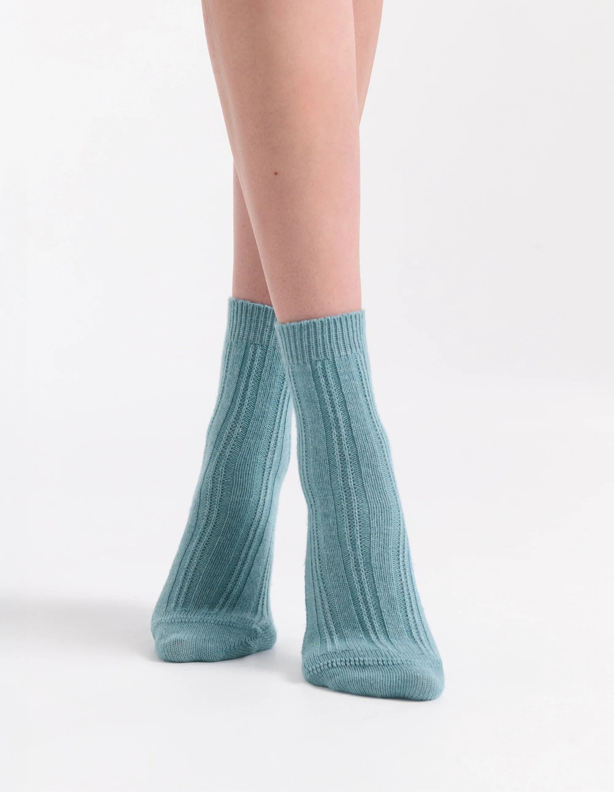 A pair of teal ribbed knit ankle socks featuring cable crew design made from soft breathable material
