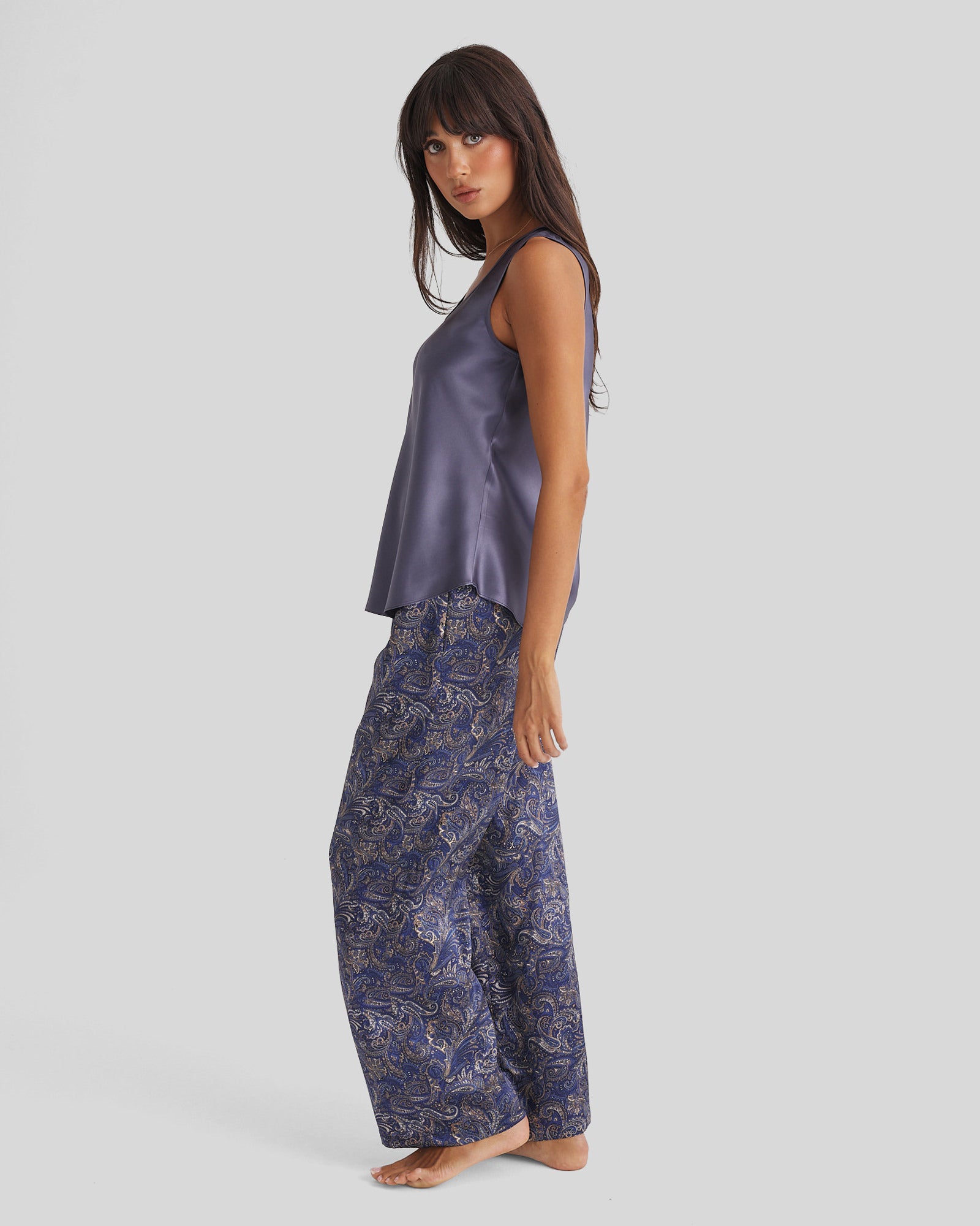 Woman in muted purple satin top and Blue Paisley Silk Pyjama Pants